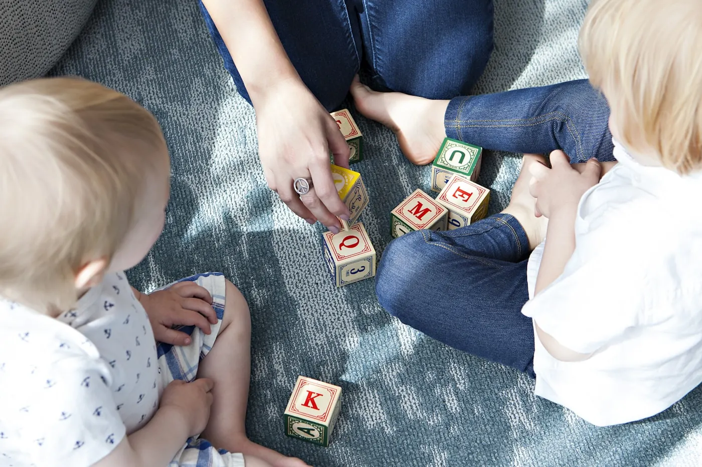 A child building a skill with materials alongside a practitioner.